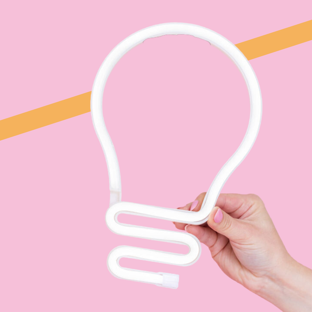 Hand holding a white neon lightbulb